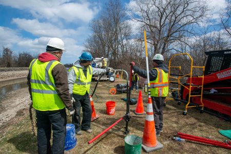 Crew working on the Erie Canal to stabilize the soil and prevent further water erosion.
